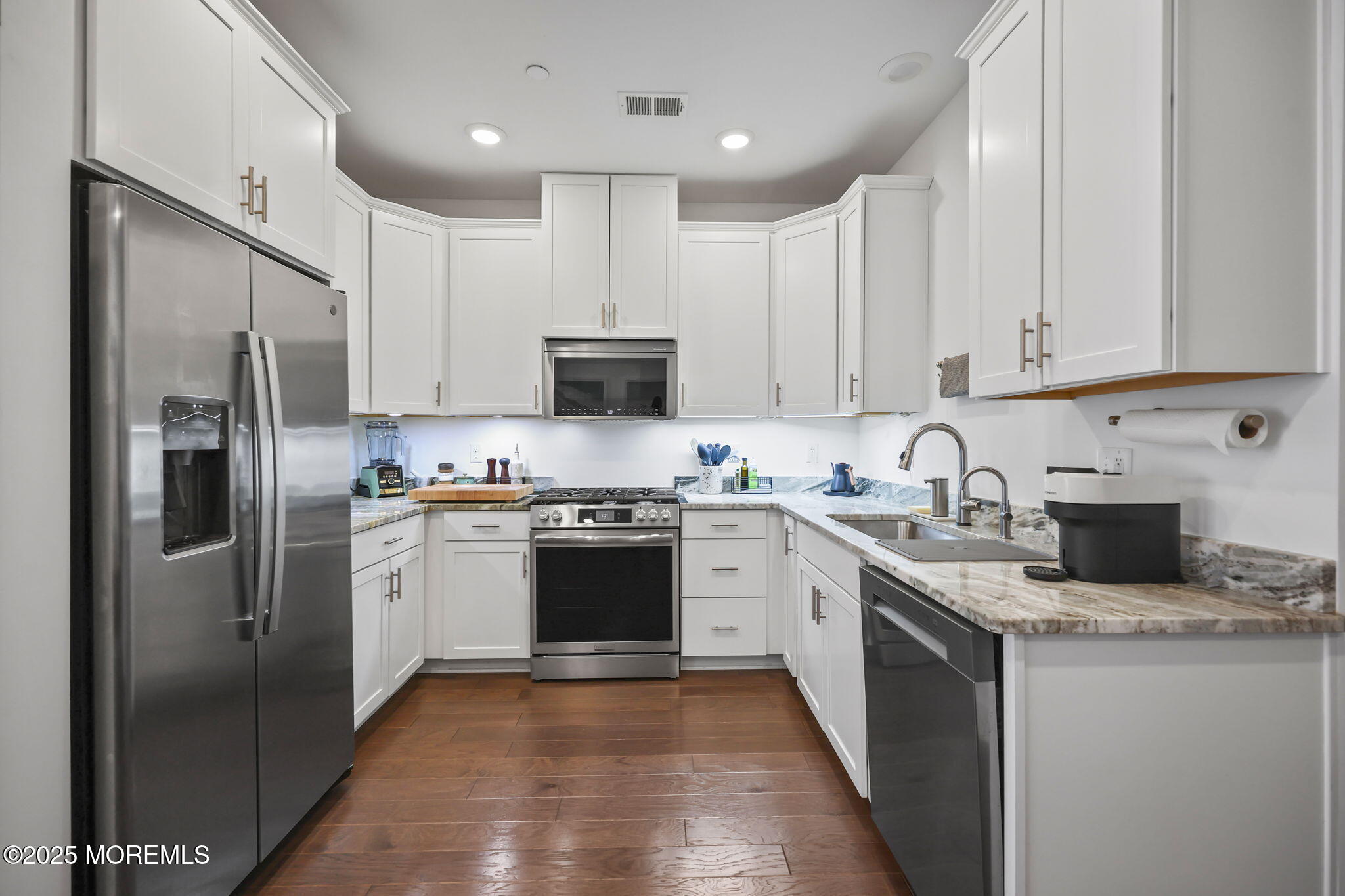 43 Midway Road North Tinton Falls, NJ 07724 - Photo 9 of 20 a kitchen with stainless steel appliances granite countertop a refrigerator stove microwave and sink