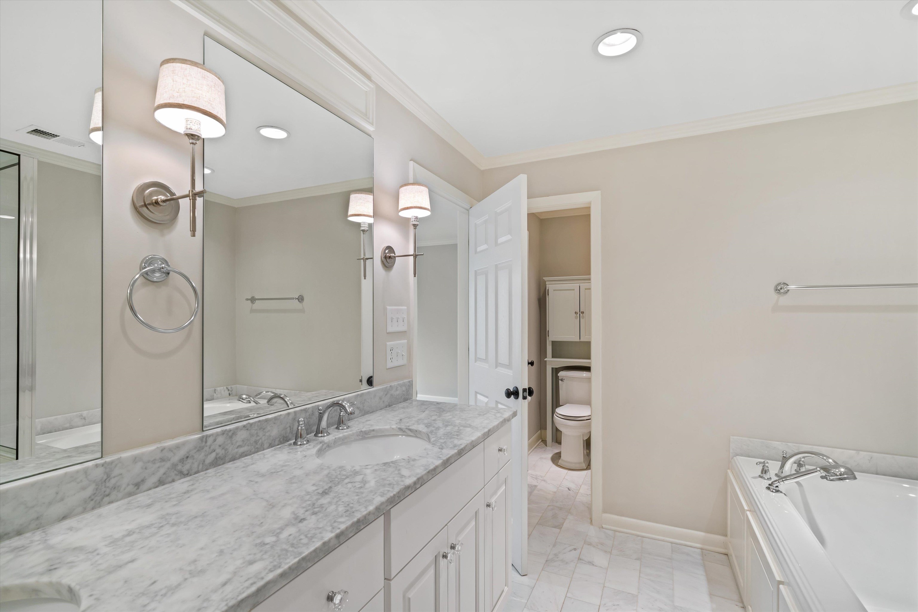 317 Pidgeon Road Memphis, TN 38117 - Photo 14 of 25 a bathroom with a granite countertop sink and a mirror