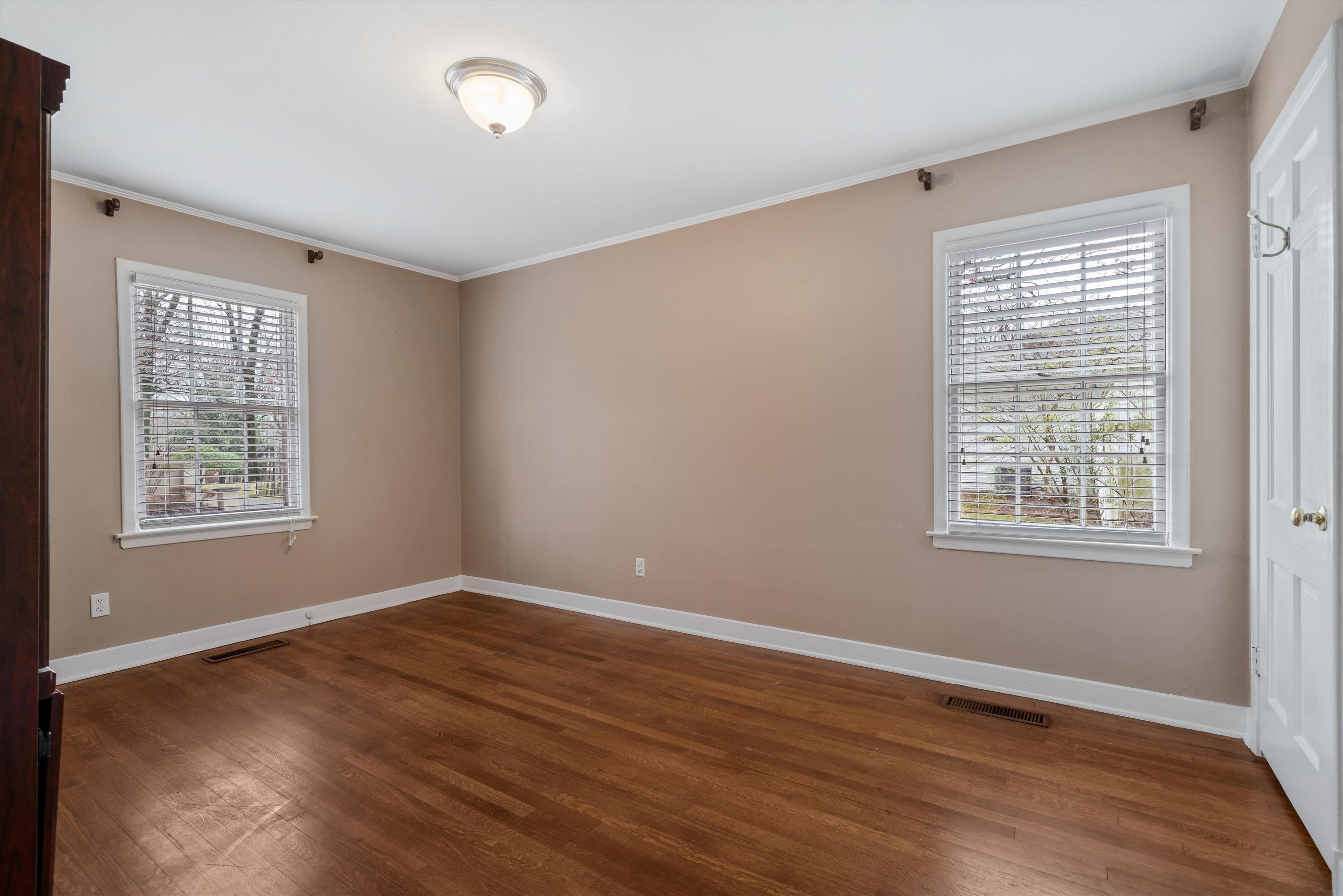 317 Pidgeon Road Memphis, TN 38117 - Photo 20 of 25 a view of an empty room with wooden floor and a window