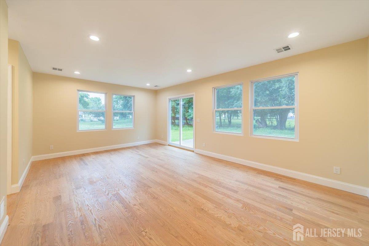 17 4th Street Hillsborough, NJ 08821 - Photo 12 of 33 a view of an empty room with a window and wooden floor