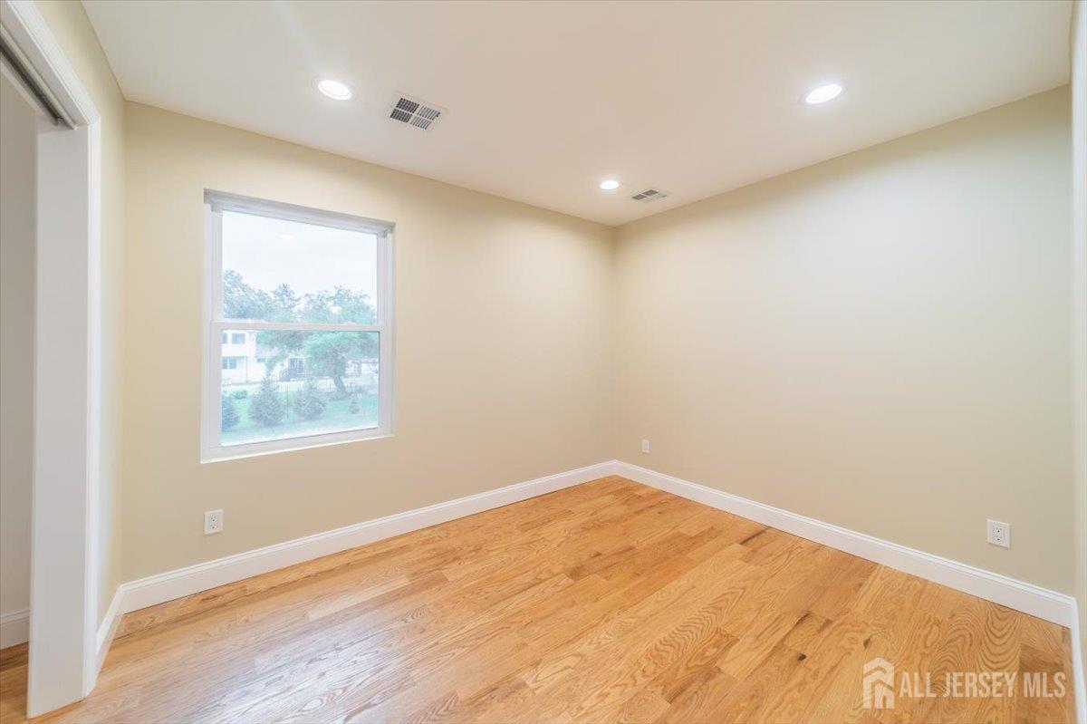 17 4th Street Hillsborough, NJ 08821 - Photo 18 of 33 an empty room with wooden floor and windows