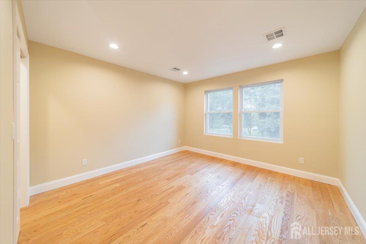 17 4th Street Hillsborough, NJ 08821 - Photo 20 of 33 an empty room with wooden floor and windows