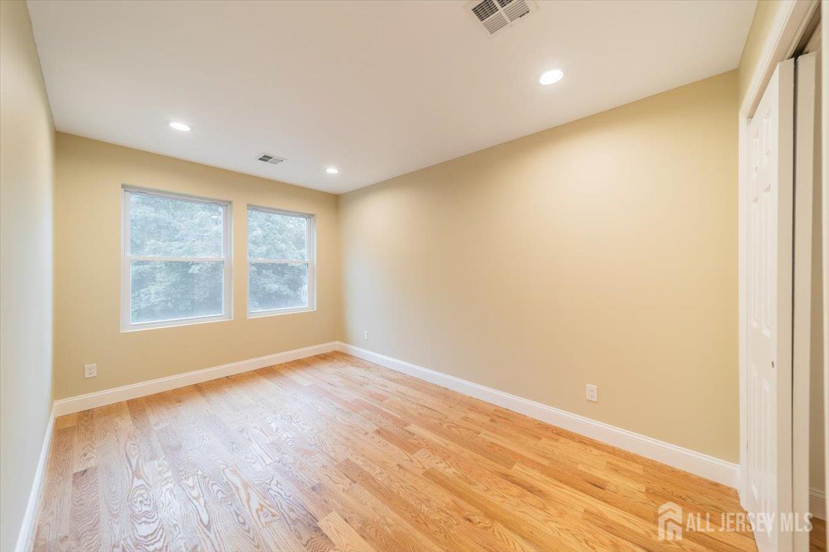17 4th Street Hillsborough, NJ 08821 - Photo 22 of 33 a view of an empty room with wooden floor and a window