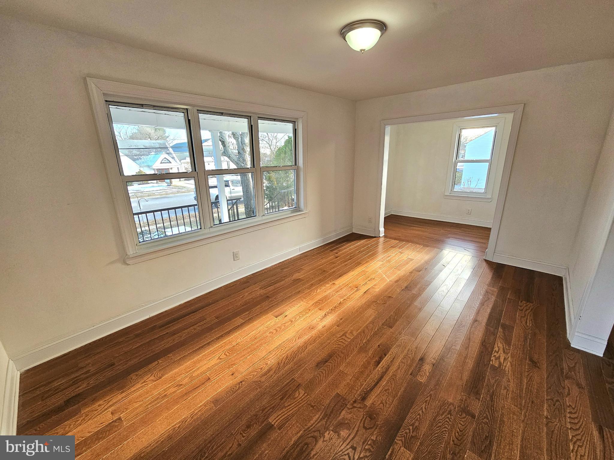 332 East Linden Avenue Lindenwold, NJ 08021 - Photo 11 of 25 a view of an empty room with wooden floor and a window