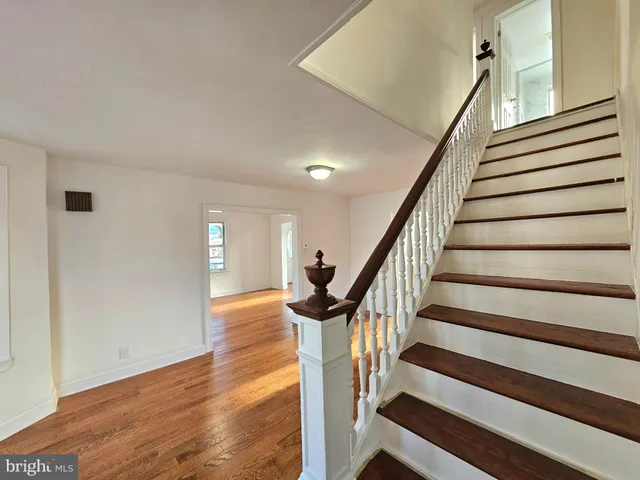 a view of entryway with wooden floor and stairs