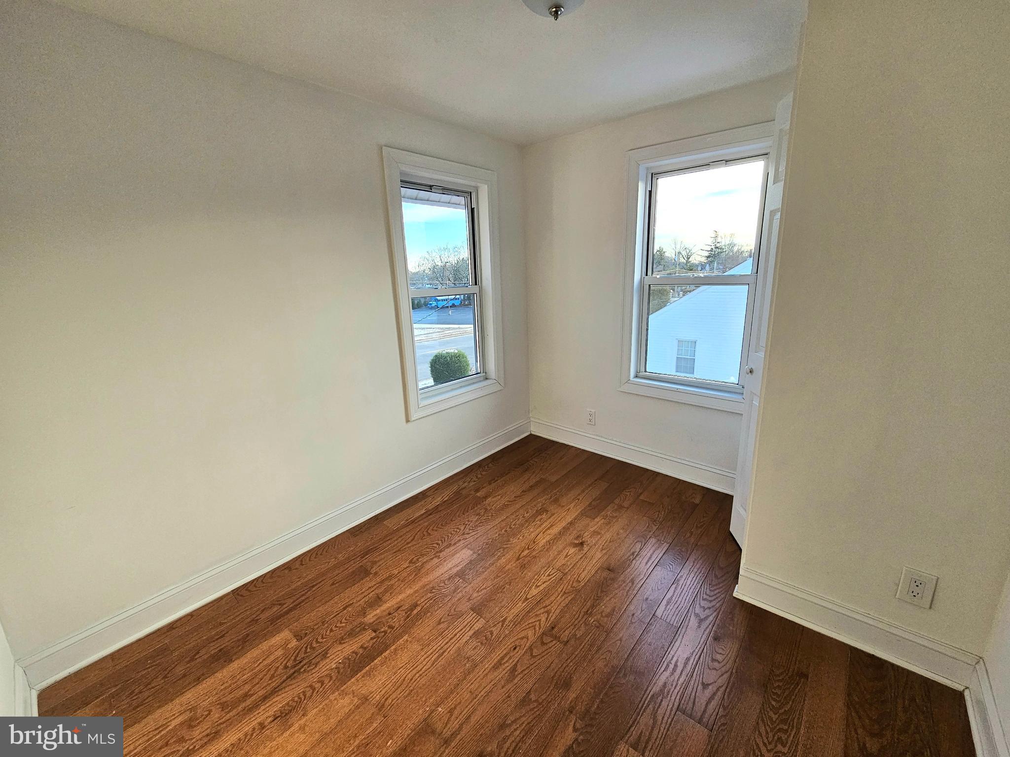 332 East Linden Avenue Lindenwold, NJ 08021 - Photo 13 of 25 an empty room with wooden floor and windows