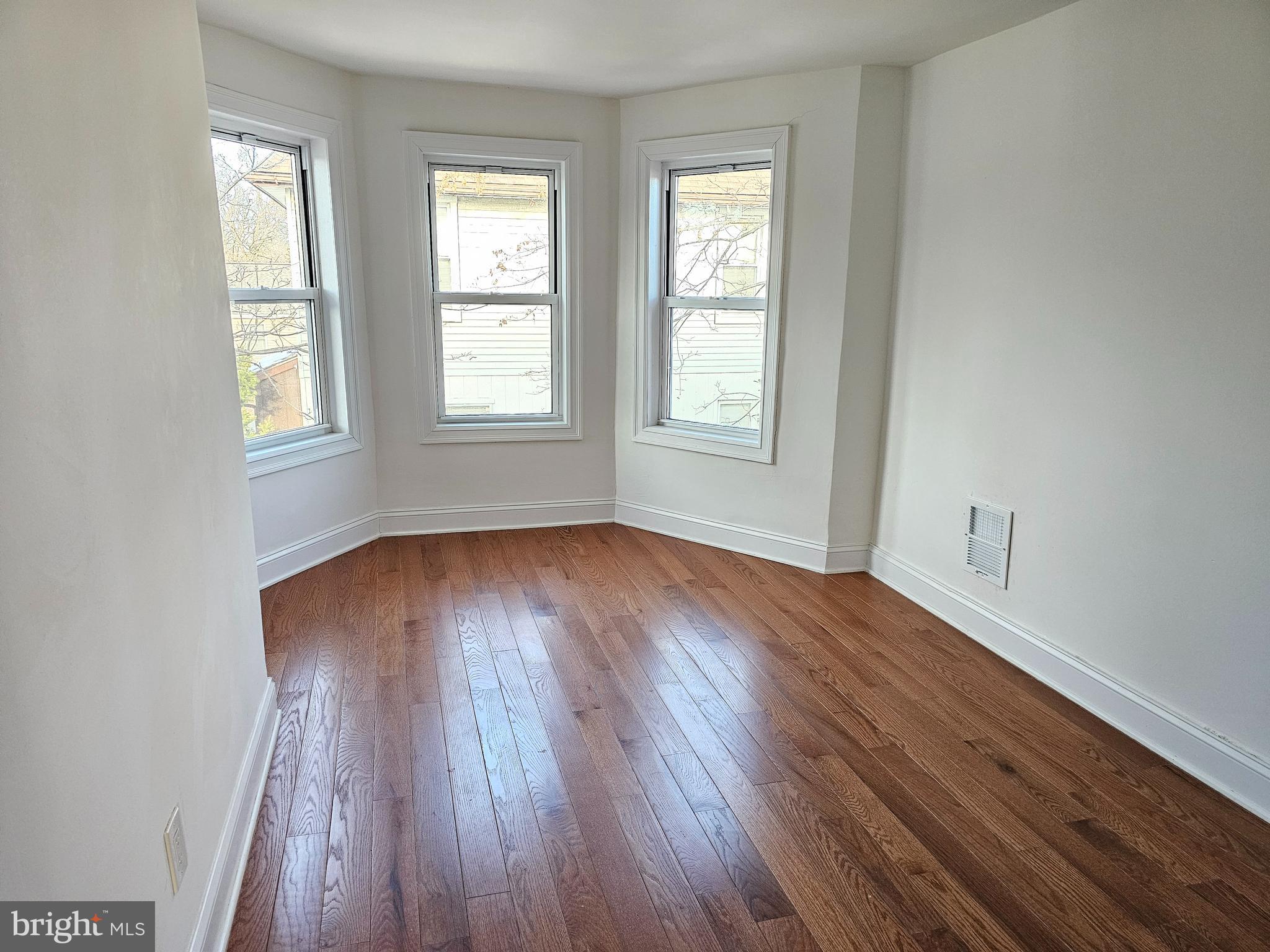332 East Linden Avenue Lindenwold, NJ 08021 - Photo 15 of 25 an empty room with wooden floor and windows