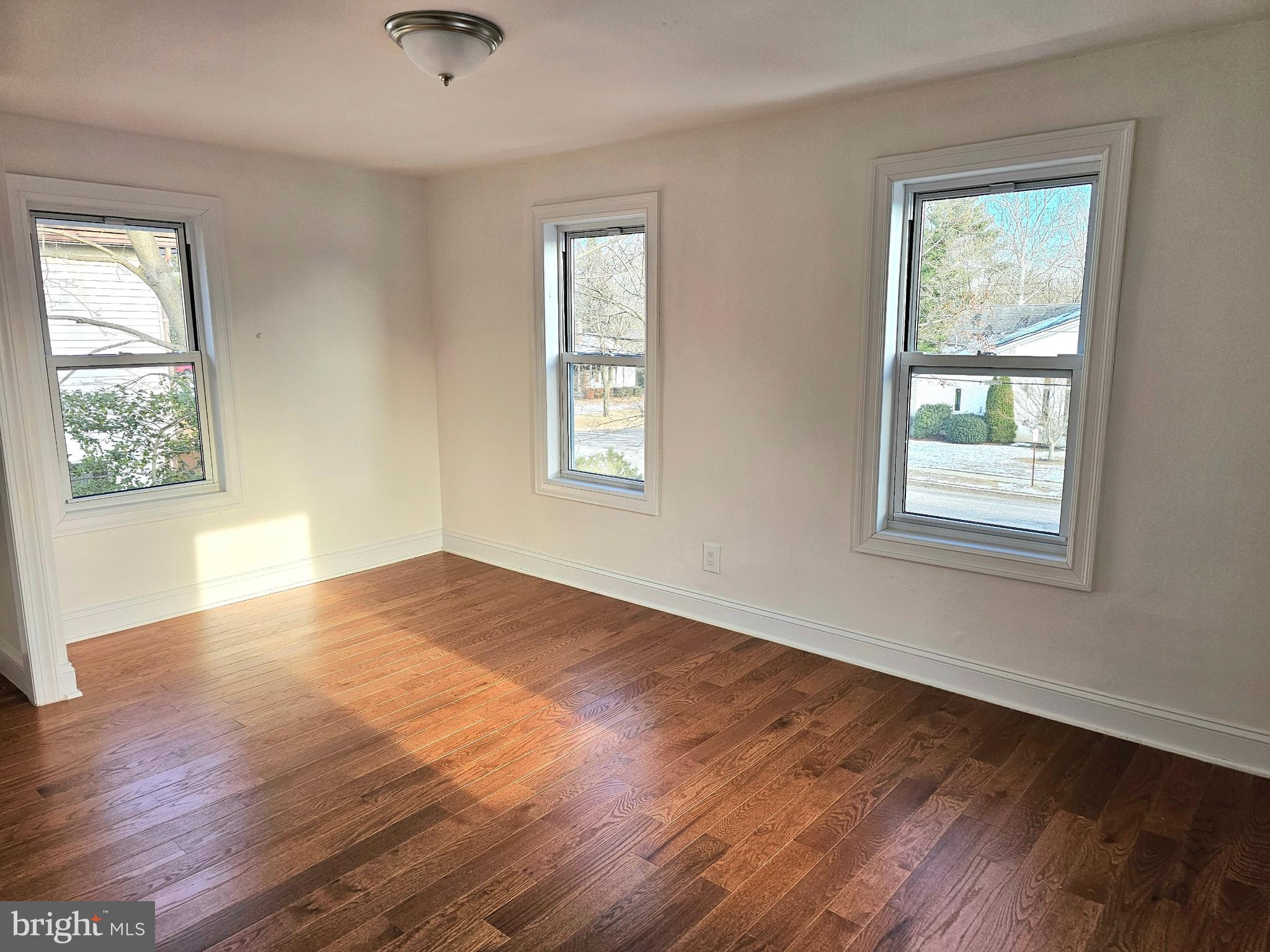 332 East Linden Avenue Lindenwold, NJ 08021 - Photo 17 of 25 a view of an empty room with wooden floor and a window