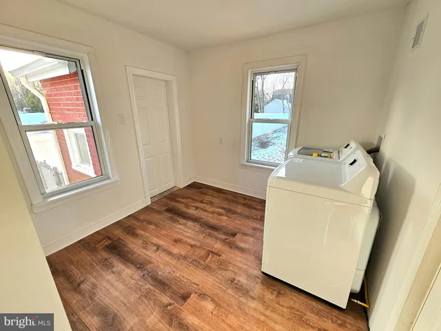 a room with a bed and wooden floor