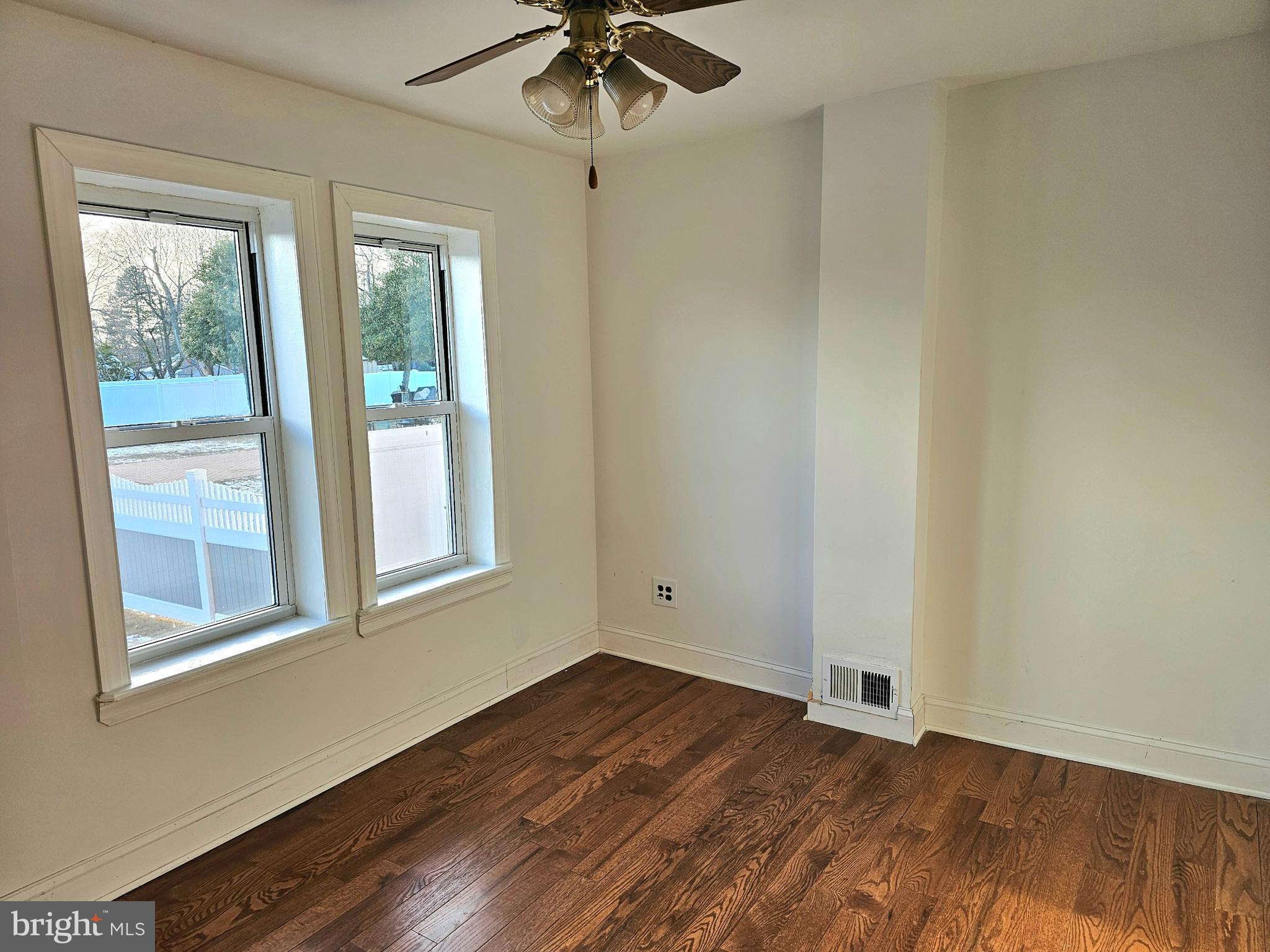 332 East Linden Avenue Lindenwold, NJ 08021 - Photo 9 of 25 an empty room with wooden floor fan and windows