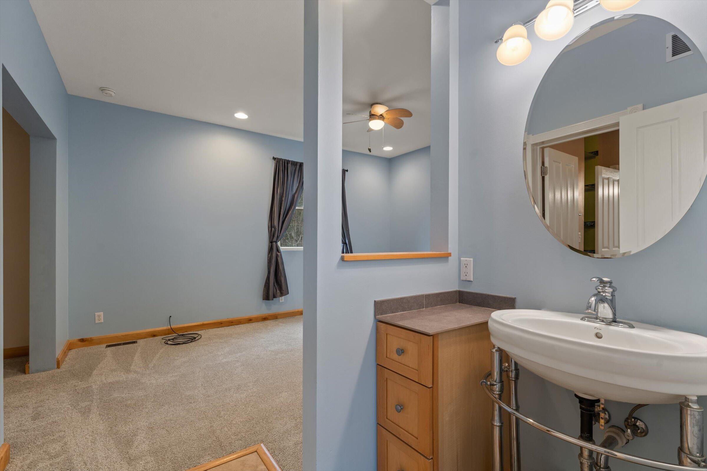 7692 North Emery Road Rolling Prairie, IN 46371 - Photo 36 of 69 a bathroom with a sink and a mirror