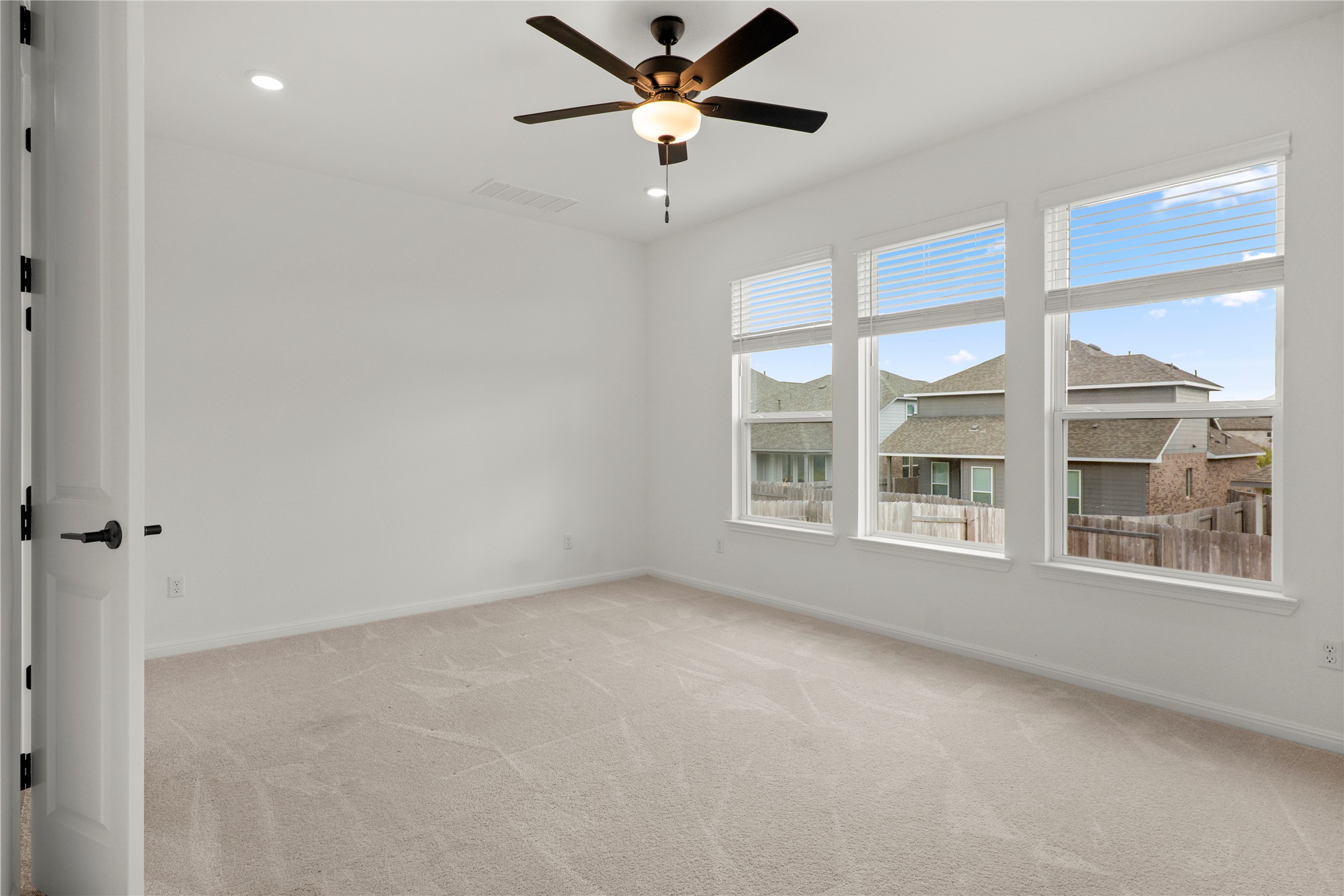 236 Wingstem Way Georgetown, TX 78633 - Photo 5 of 19 A quiet, carpeted bedroom offers abundant natural light and a ceiling fan for comfort.