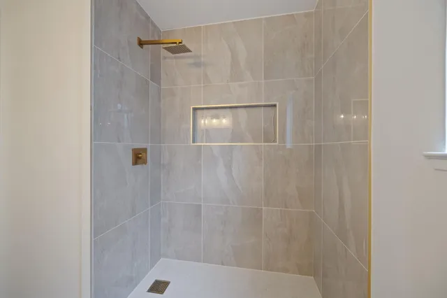 a bathroom with a glass shower door