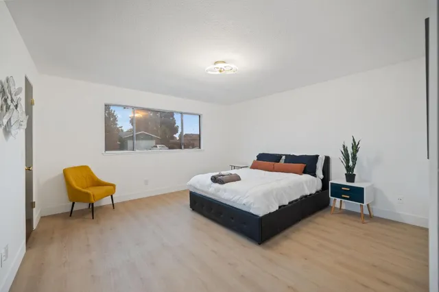 a bedroom with a bed and a chair