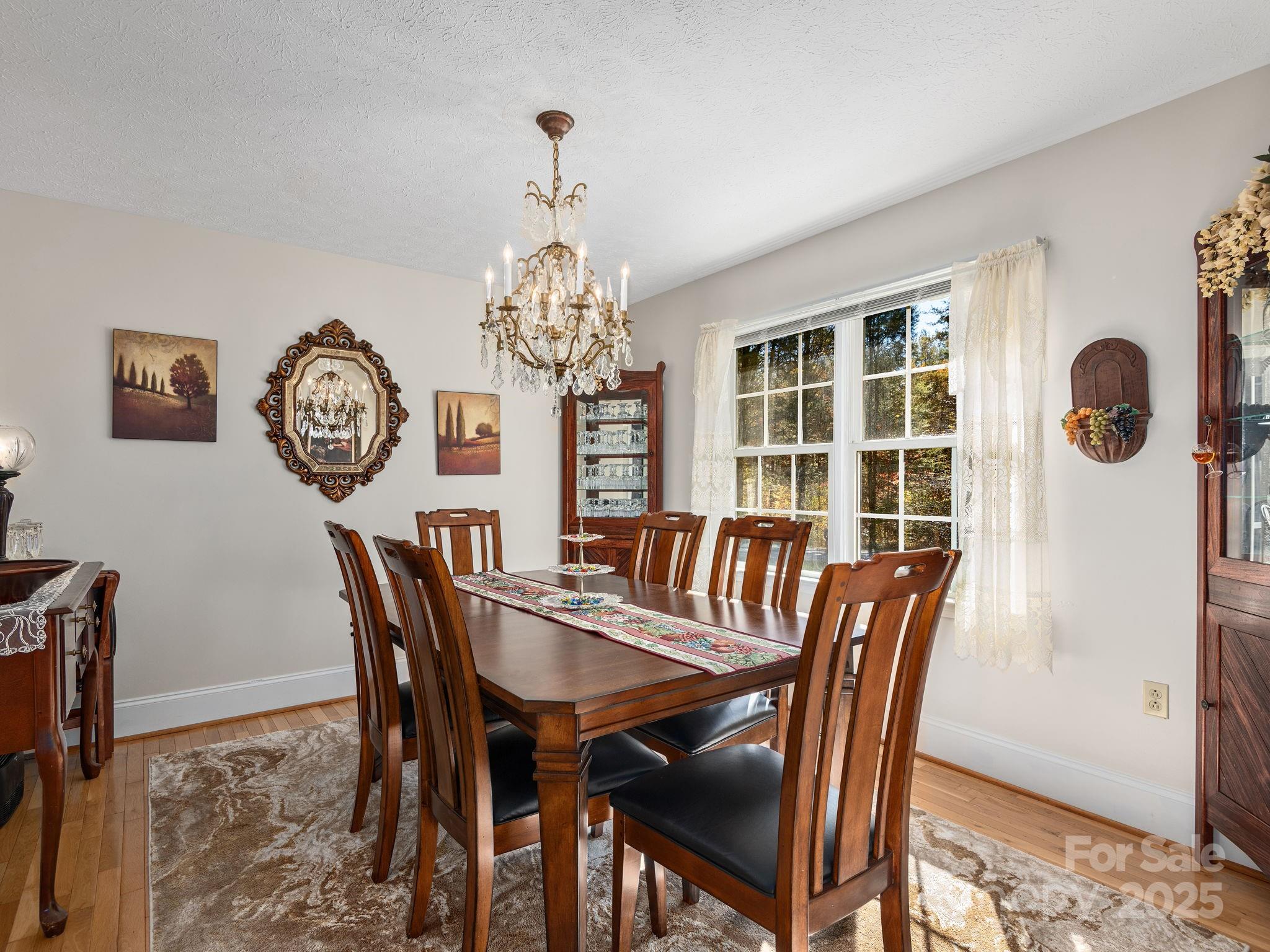 201 Sean Way Hendersonville, NC 28792 - Photo 5 of 24 a view of a dining room with furniture and a chandelier