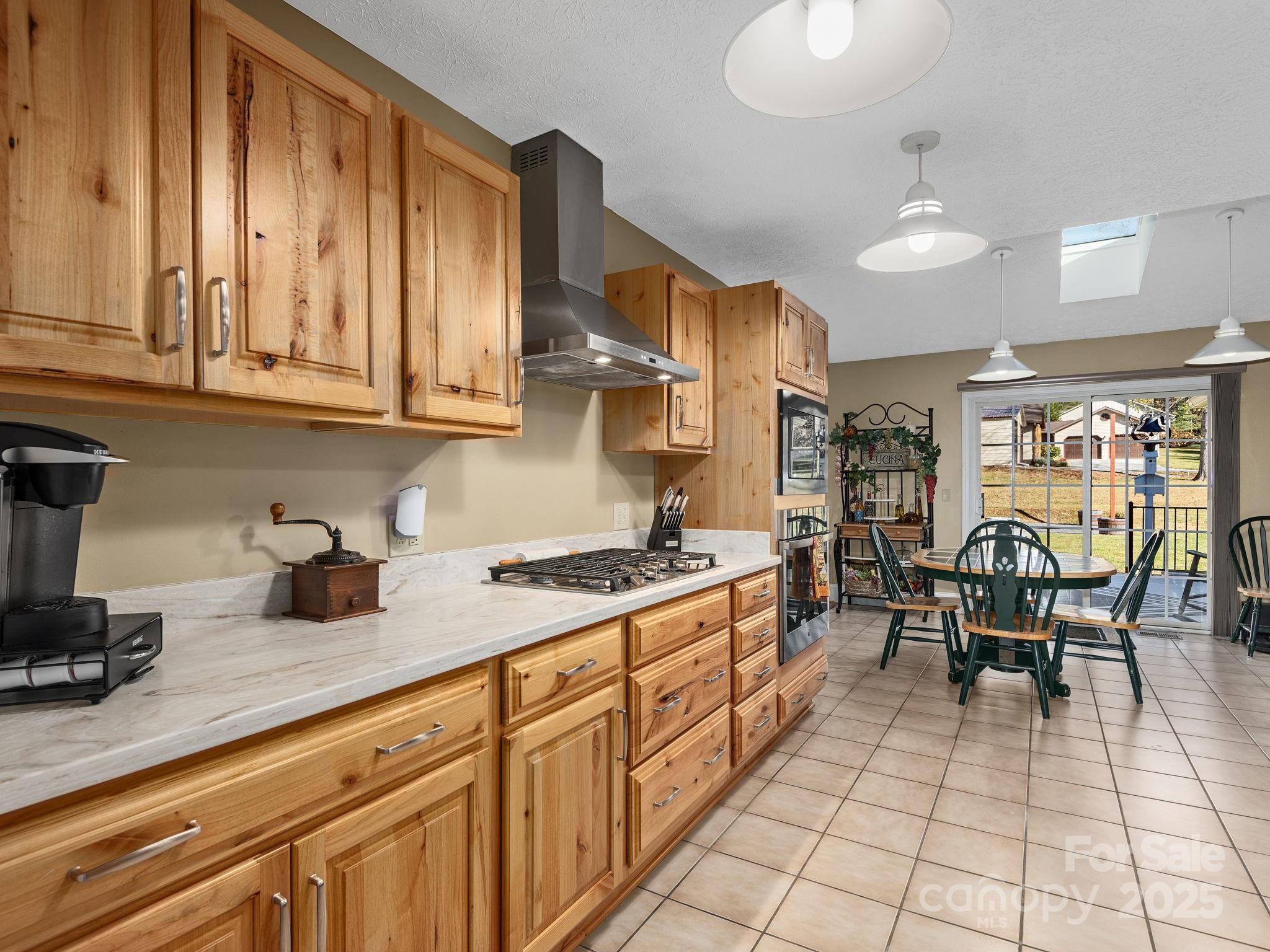 201 Sean Way Hendersonville, NC 28792 - Photo 7 of 24 a kitchen with stainless steel appliances granite countertop a stove a sink and a microwave