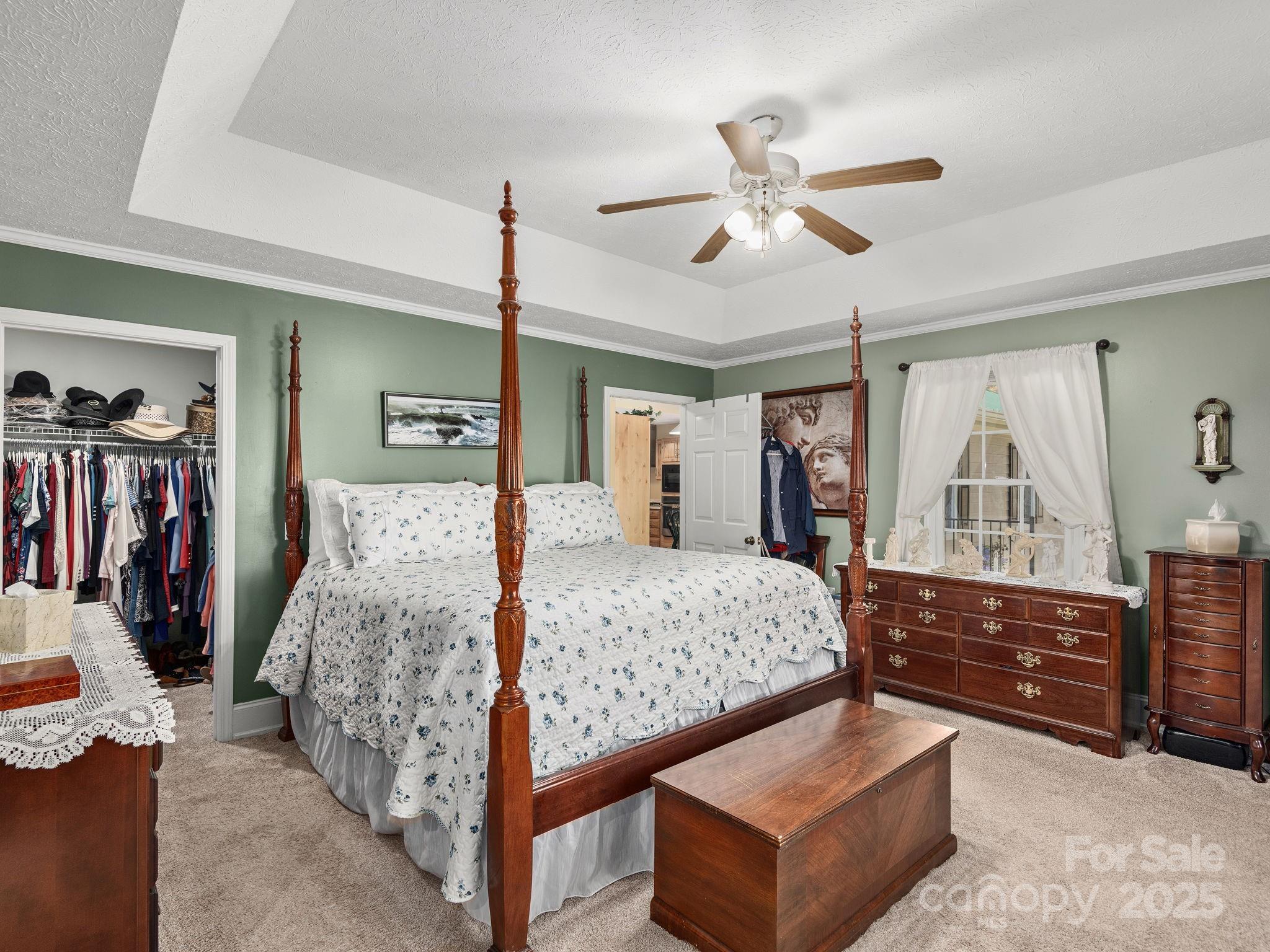 201 Sean Way Hendersonville, NC 28792 - Photo 9 of 24 a bedroom with a large bed and a chandelier