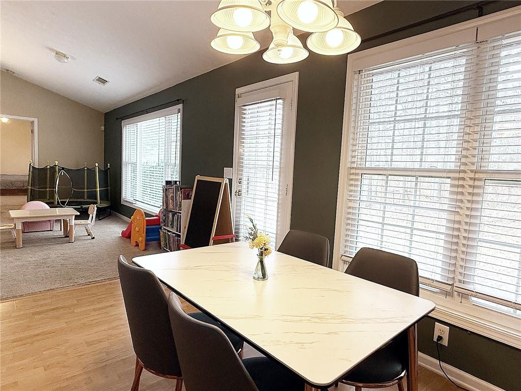 69 Morning Top Court Suwanee, GA 30024 - Photo 14 of 34 a view of a dining room with furniture and window