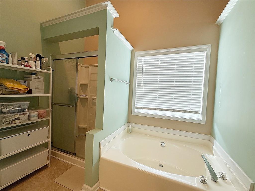 69 Morning Top Court Suwanee, GA 30024 - Photo 19 of 34 a bathroom with a bathtub and a window