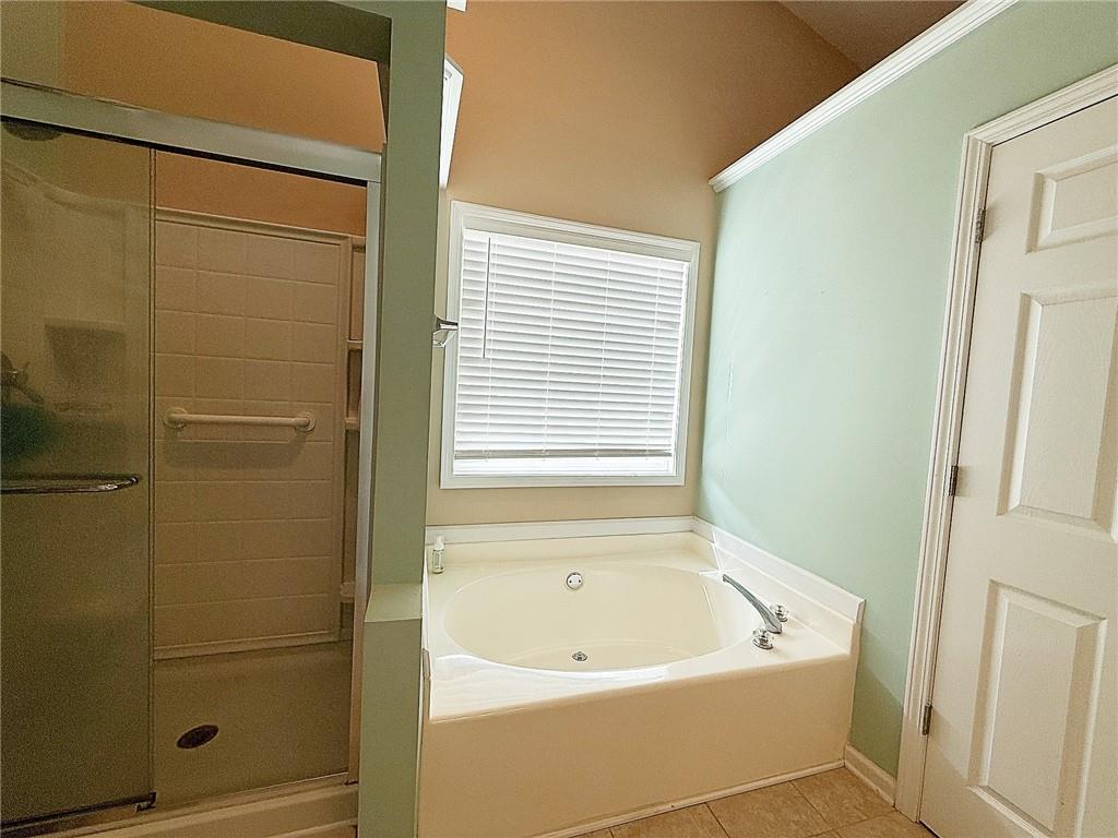 69 Morning Top Court Suwanee, GA 30024 - Photo 20 of 34 a bathroom with a bathtub and shower