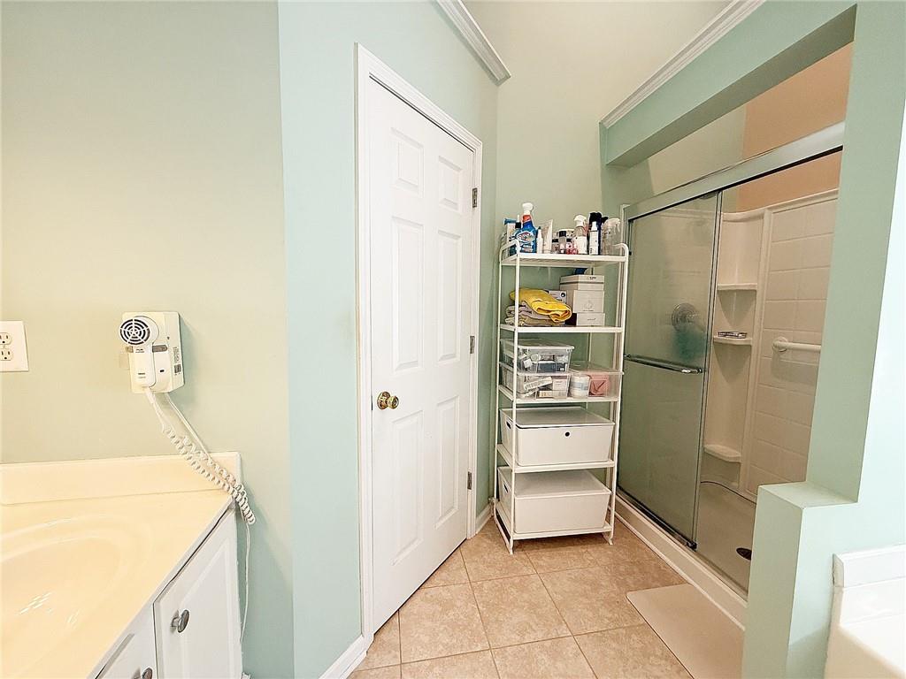 69 Morning Top Court Suwanee, GA 30024 - Photo 21 of 34 a bathroom with a tub sink and mirror