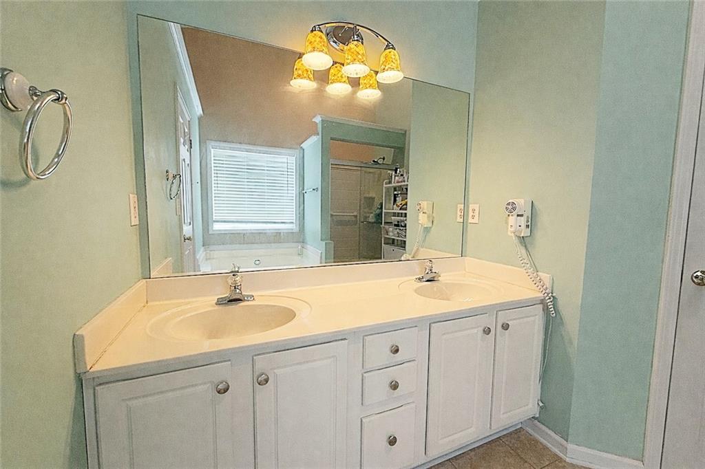69 Morning Top Court Suwanee, GA 30024 - Photo 23 of 34 a bathroom with a sink and a mirror