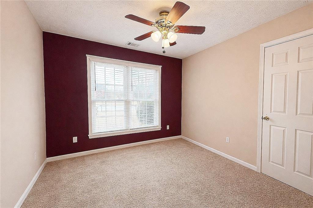 69 Morning Top Court Suwanee, GA 30024 - Photo 26 of 34 an empty room with windows and fan