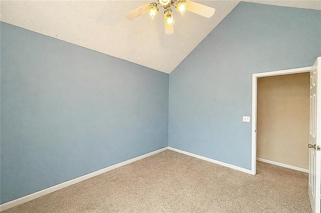 69 Morning Top Court Suwanee, GA 30024 - Photo 29 of 34 an empty room with a chandelier fan