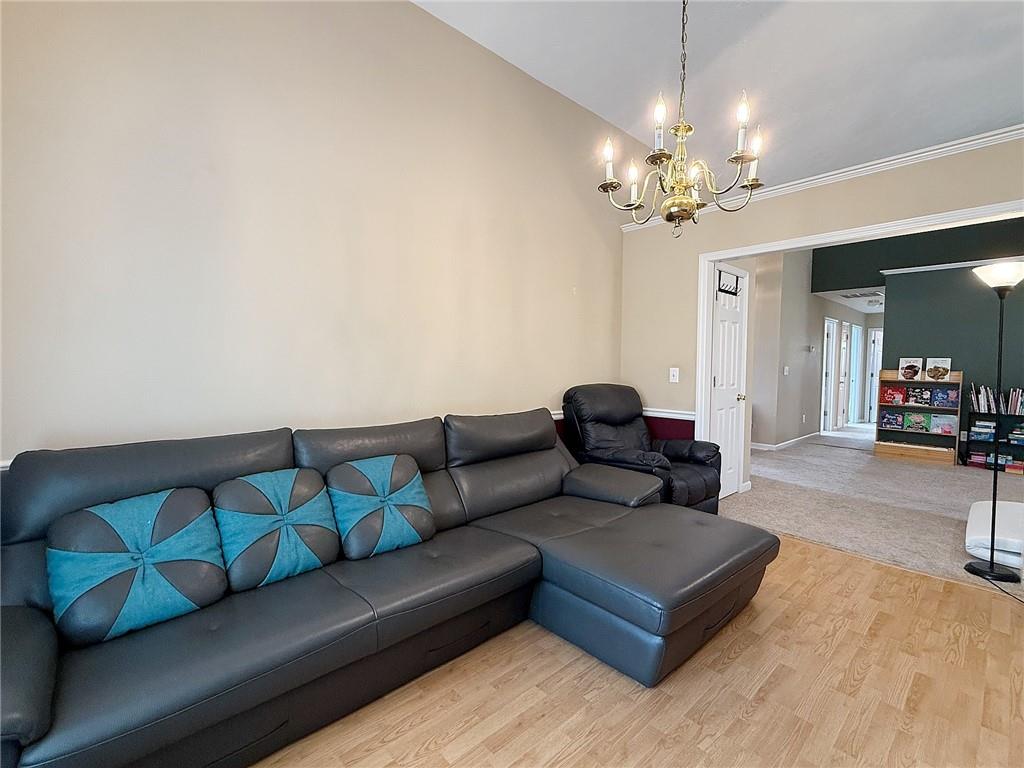 69 Morning Top Court Suwanee, GA 30024 - Photo 7 of 34 a living room with furniture and a chandelier