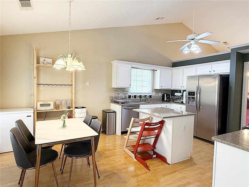 69 Morning Top Court Suwanee, GA 30024 - Photo 10 of 34 a kitchen with a dining table chairs stainless steel appliances and cabinets