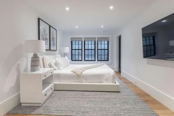 a large white bed in a white room