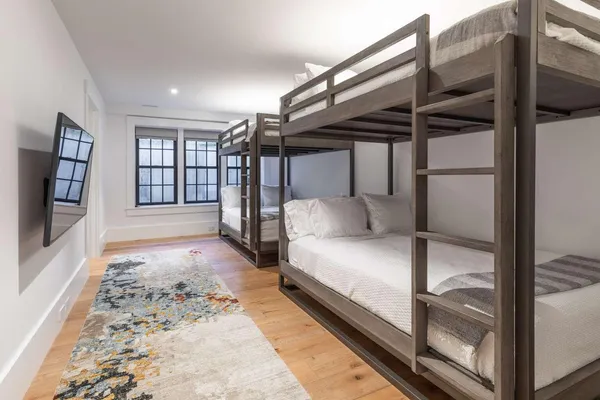 a bedroom with a bed and glass door