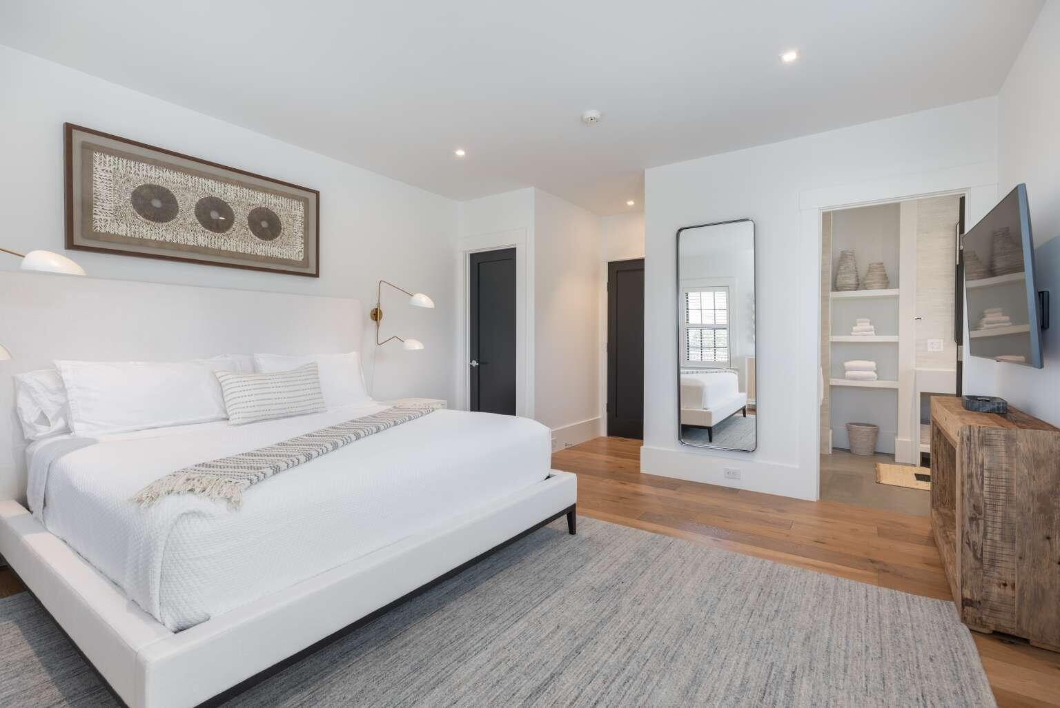 11 A Meadow Lane, Unit B Nantucket, MA 02554 - Photo 15 of 20 a bedroom with a large bed and glass door