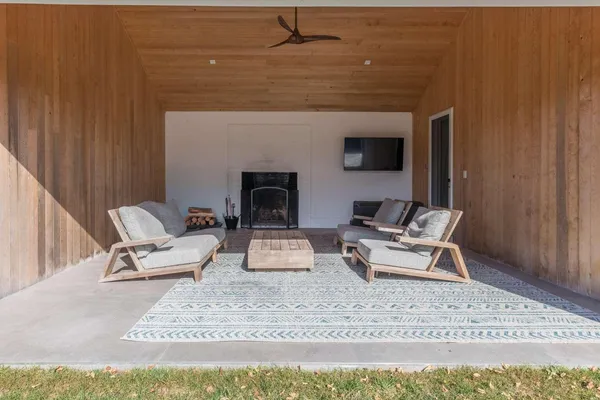 a living room with furniture and a fireplace