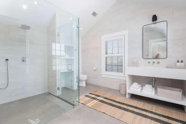 a spacious bathroom with double vanity and a shower