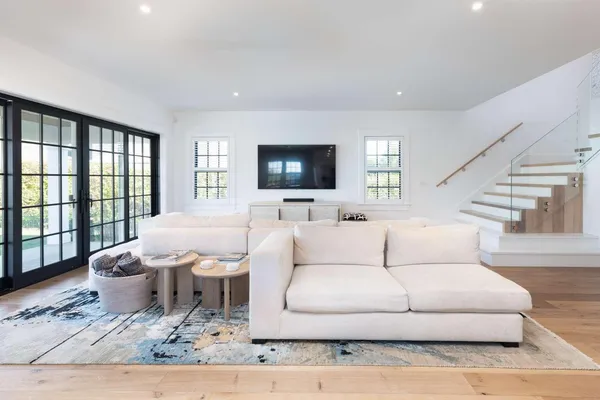 a living room with furniture window and a flat screen tv