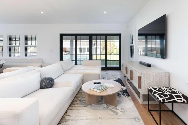 a living room with furniture a rug and a window