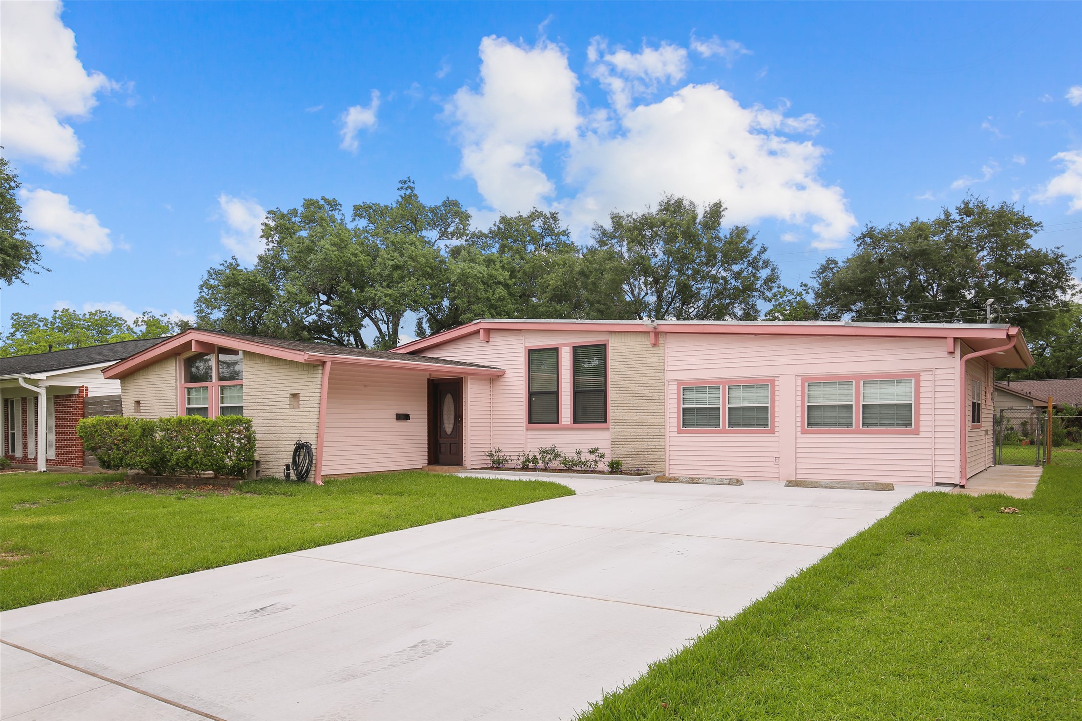 a front view of house with yard and green space