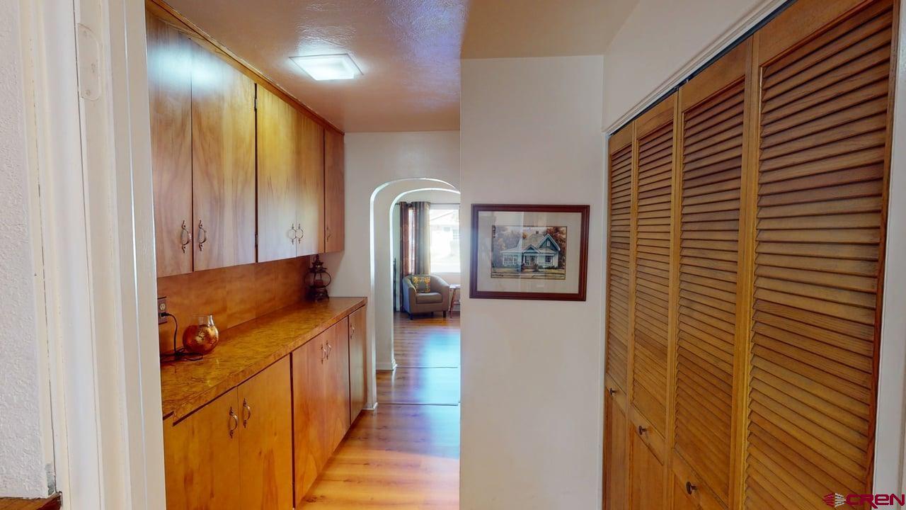 96 El Rio Drive Alamosa, CO 81101 - Photo 11 of 18 a view of a hallway with wooden floor and staircase