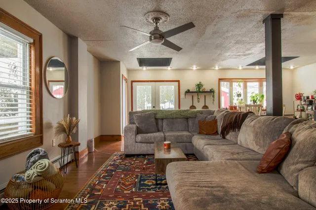a view of a dining room with furniture and a window