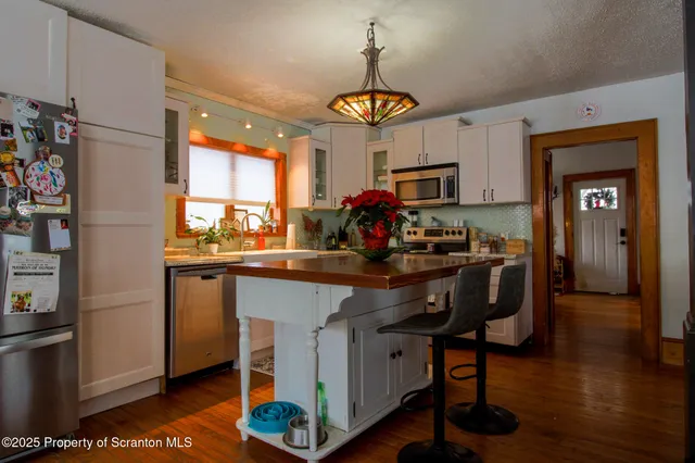 a kitchen with a sink appliances and cabinets