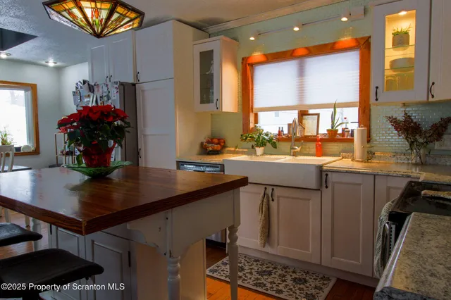 a bathroom with a sink a toilet a mirror and shower