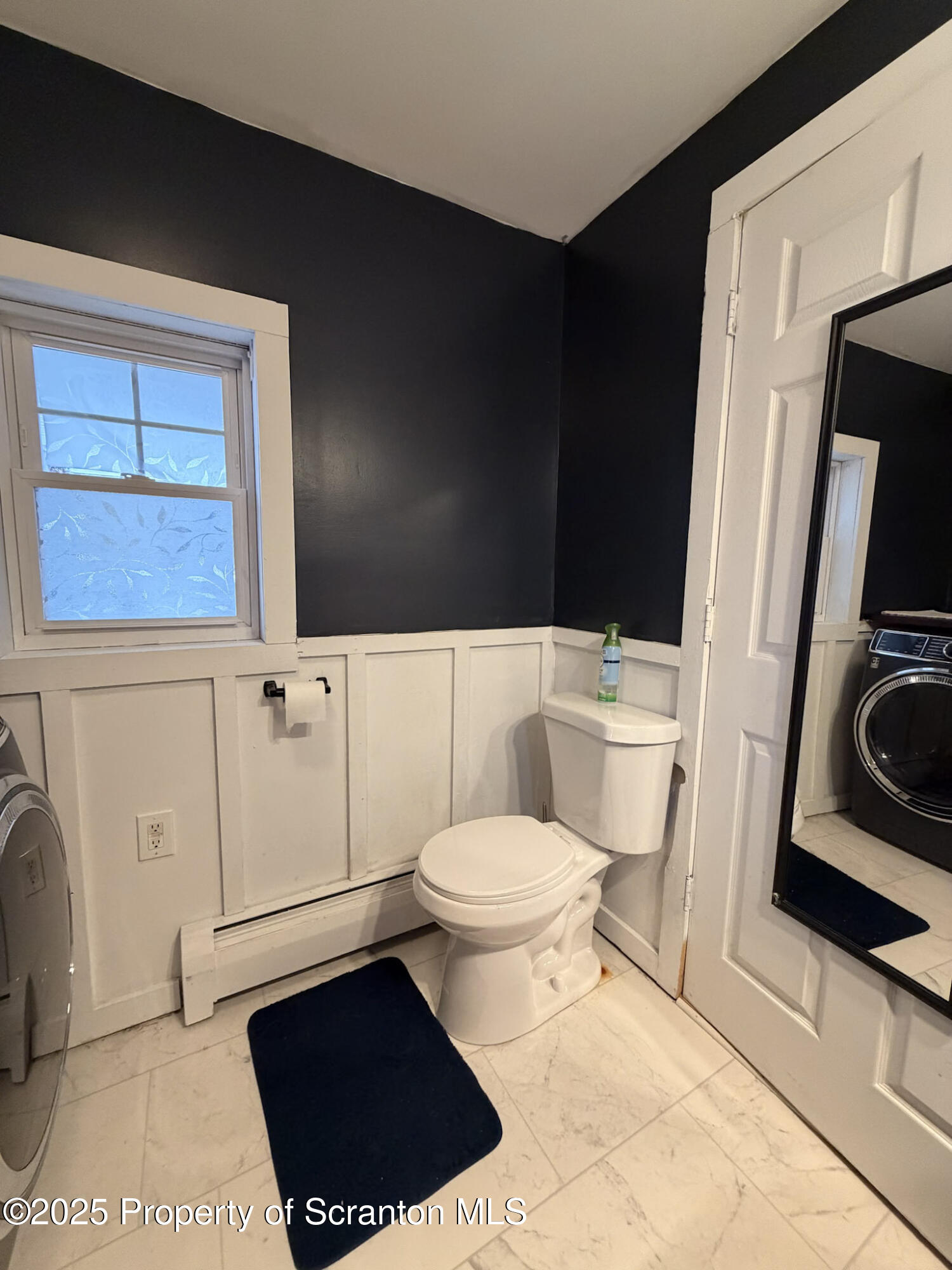 316 Bridge Street Blakely, PA 18452 - Photo 18 of 39 a bathroom with a toilet a sink and a mirror