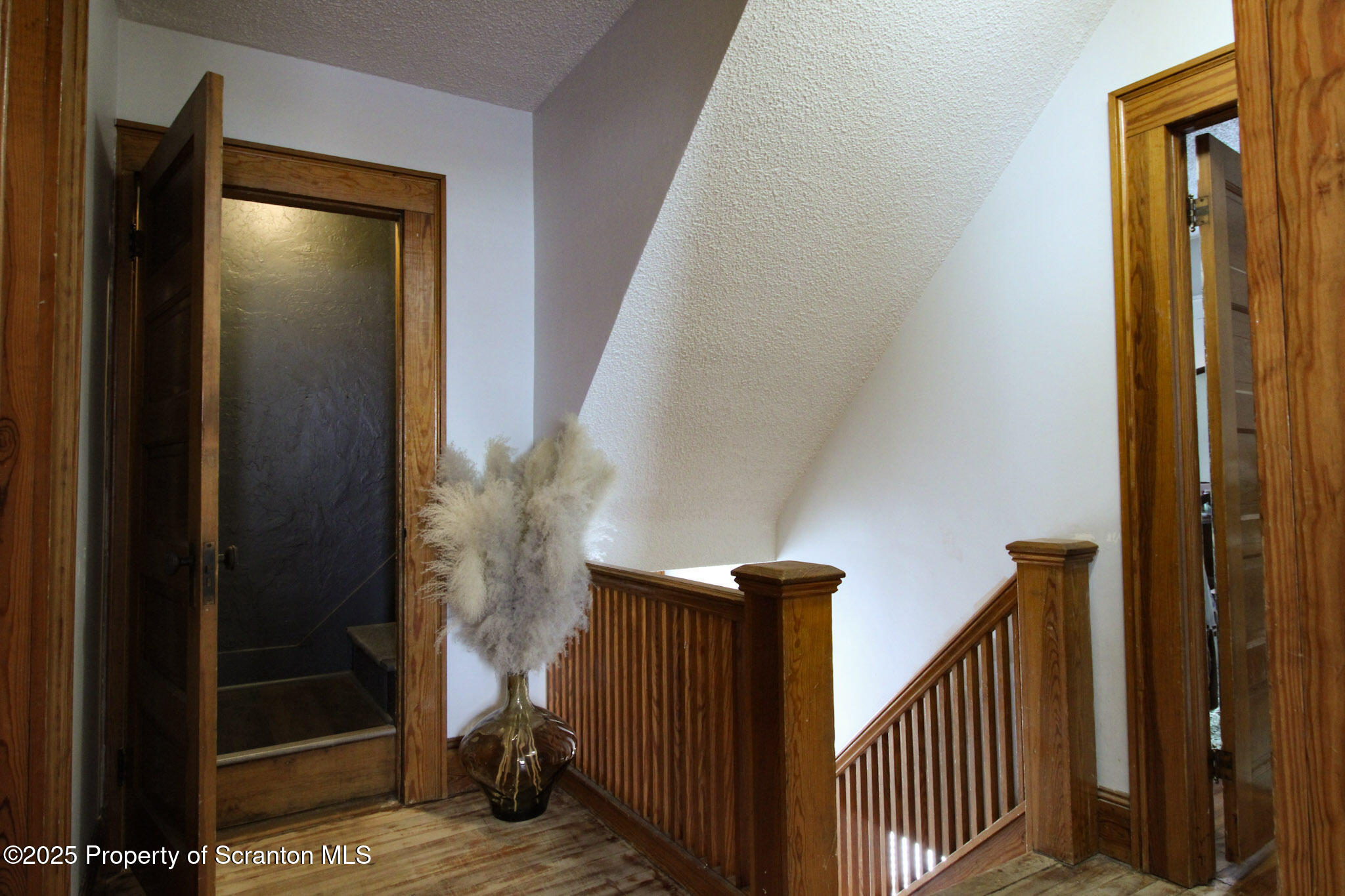 316 Bridge Street Blakely, PA 18452 - Photo 21 of 39 a view of a livingroom with stairs and a hallway