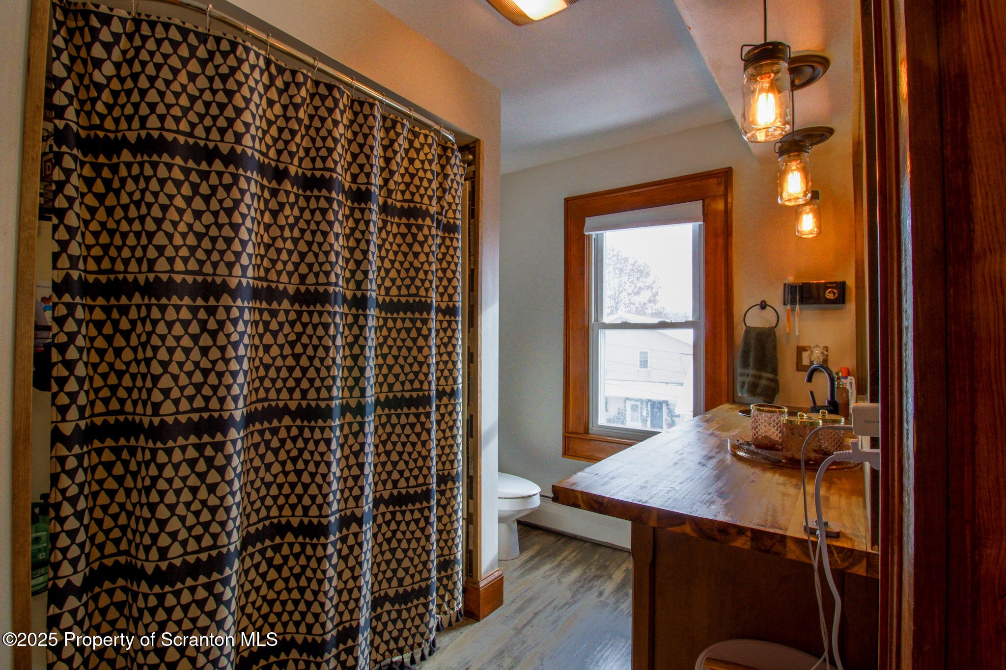 316 Bridge Street Blakely, PA 18452 - Photo 22 of 39 a bathroom with a sink a toilet a mirror and shower