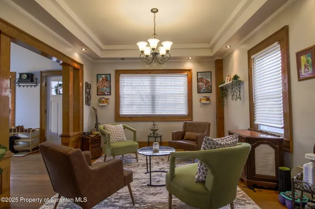 a kitchen with stainless steel appliances granite countertop a stove a refrigerator a sink dishwasher a dining table and chairs with wooden floor