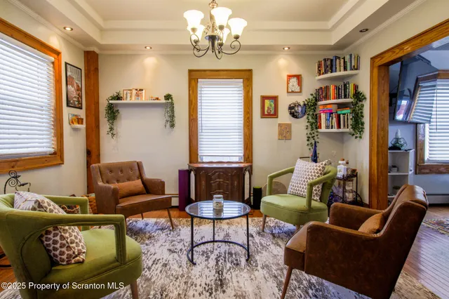 a kitchen with stainless steel appliances granite countertop a sink a stove top oven a chimney and a dining table