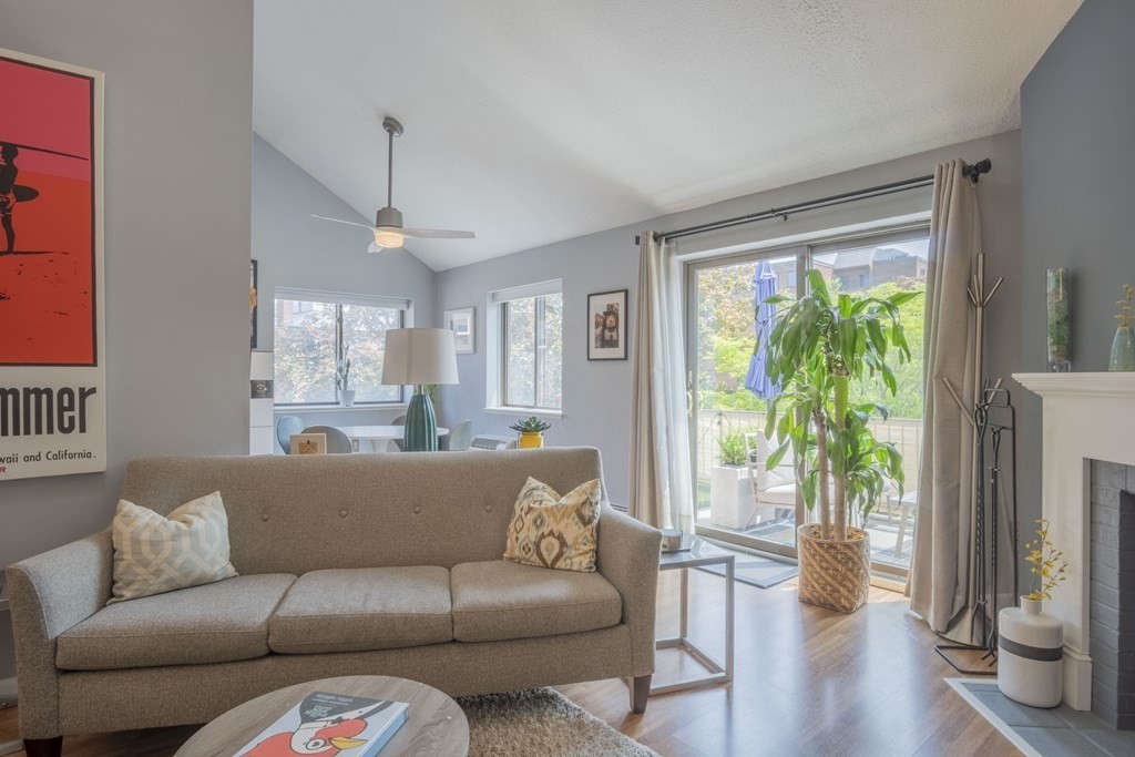 9 Barton Square, Unit 201 Salem, MA 01970 - Photo 11 of 42 a living room with furniture and a large window with wooden floor