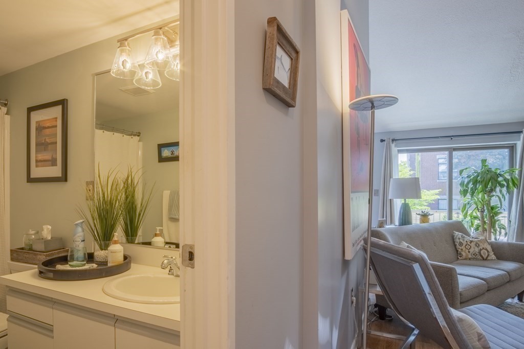 9 Barton Square, Unit 201 Salem, MA 01970 - Photo 12 of 42 a bathroom with a granite countertop sink and a mirror