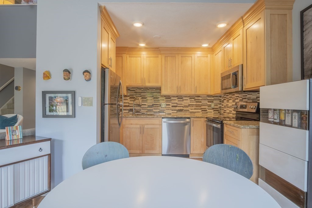 9 Barton Square, Unit 201 Salem, MA 01970 - Photo 16 of 42 a bathroom with stainless steel appliances a sink and a refrigerator